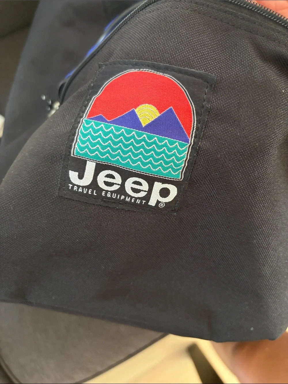 Jeep blue and black duffel bag with front mesh pocket.